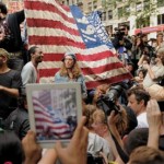 A person with an iPad takes a photograph