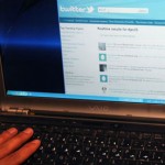 Man uses Twitter on his laptop