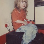 A four-year-old Adele strums on the strings of her toy instrument as she opens up her photo album