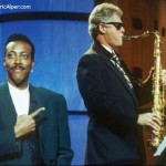 Arsenio Hall pointing at Bill Clinton playing the sax