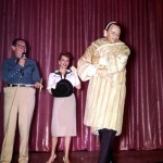 Frank Sinatra models a fur at the charity auction for the 1959 Share, Inc. party