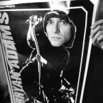 Kurt Cobain peeking through a Bryan Adams poster.