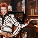 David Bowie poses beside his Rolls Royce, ca. 1973.