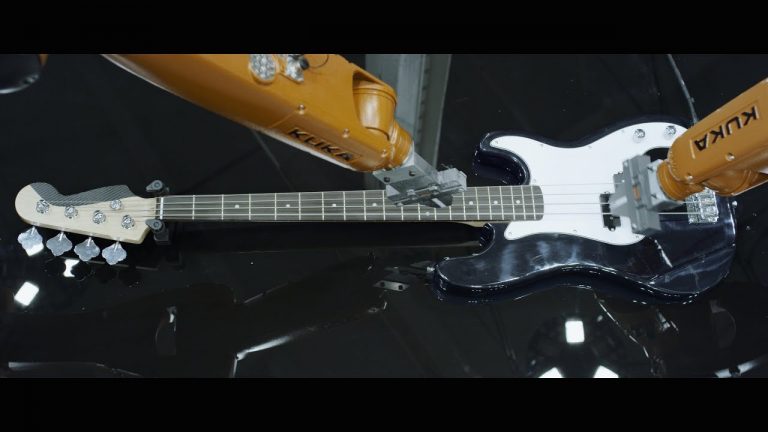 Man Performs Song With A Band Of Industrial Robotic Arms