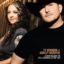 Country Icons Ty Herndon and Ashley McBryde Reimagine ‘A Man Holdin’ On (To a Woman Lettin’ Go)’ for New Era